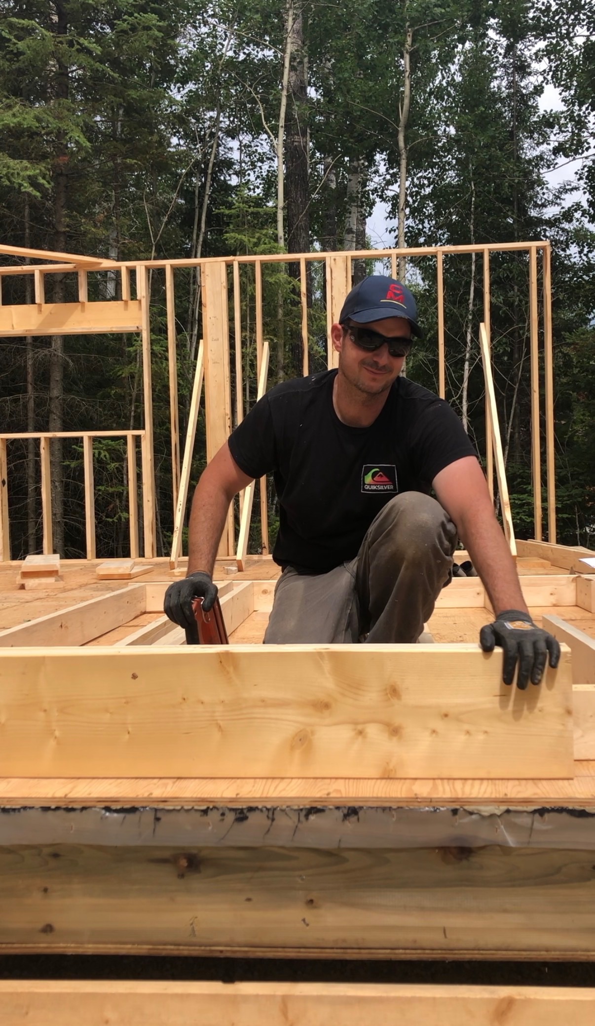 Kenny framing a wall on a job site